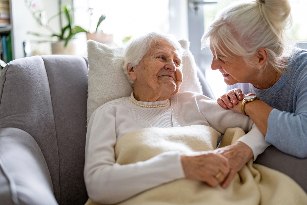 elderly woman at home with her family caregiver